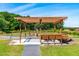 Outdoor wooden picnic pavilion with lighting, great spot for gatherings by a pond in a scenic setting at 3187 Wilsons Mills Rd, Smithfield, NC 27577