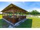 Charming wood pavilion with picnic tables, perfect for outdoor gatherings and enjoying community views at 3187 Wilsons Mills Rd, Smithfield, NC 27577