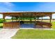 Exterior view of wood pavilion, offering a covered space for gatherings on a sunny day at 3187 Wilsons Mills Rd, Smithfield, NC 27577