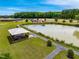 Aerial view of a pond with a gazebo, surrounding walkway, and lush greenery at 3187 Wilsons Mills Rd, Smithfield, NC 27577
