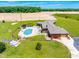 Aerial view of home with an in-ground swimming pool, patio, and lush green backyard at 3187 Wilsons Mills Rd, Smithfield, NC 27577