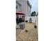 Private backyard with a stone patio, storage shed, outdoor dining set, and white privacy fence at 364 Bayleigh Ct, Garner, NC 27529