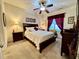 Cozy main bedroom features plush carpeting, a ceiling fan, and warm, inviting decor at 364 Bayleigh Ct, Garner, NC 27529