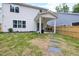 Fenced backyard with a covered patio and stepping stones, ideal for outdoor seating at 389 Whetstone Dr, Angier, NC 27501