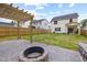 View of patio with fire pit and backyard, perfect for outdoor entertaining and relaxation at 389 Whetstone Dr, Angier, NC 27501