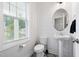Charming powder room with shiplap walls, patterned tile flooring, and a pedestal sink for a modern touch at 389 Whetstone Dr, Angier, NC 27501