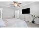 Well-lit bedroom with a ceiling fan, TV, and neutral décor at 389 Whetstone Dr, Angier, NC 27501