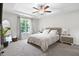 Bright bedroom with a ceiling fan, large window and neutral color palette at 389 Whetstone Dr, Angier, NC 27501