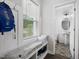 Bright entryway with bench seating, storage, and a convenient powder room with stylish patterned flooring at 389 Whetstone Dr, Angier, NC 27501
