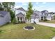 Beautiful landscaped front lawn and two-story home with stone accents, a two-car garage, and inviting curb appeal at 389 Whetstone Dr, Angier, NC 27501