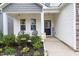 Cozy front porch with seating, decorative plants, and a welcoming entrance to the home at 389 Whetstone Dr, Angier, NC 27501
