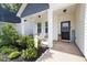 Charming front porch featuring seating and decorative accents, enhancing curb appeal and creating a welcoming entrance at 389 Whetstone Dr, Angier, NC 27501