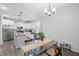 Bright kitchen boasts white cabinets, stainless steel appliances, and a dining area for seamless entertaining at 389 Whetstone Dr, Angier, NC 27501