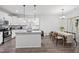 Modern kitchen with island, stainless steel appliances, granite counters, and adjacent dining area at 389 Whetstone Dr, Angier, NC 27501