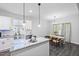 Open concept kitchen flows into the dining area, featuring granite countertops and stainless steel appliances at 389 Whetstone Dr, Angier, NC 27501
