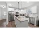 Modern kitchen features stainless steel appliances, granite countertops, and a large island with seating at 389 Whetstone Dr, Angier, NC 27501
