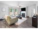 Inviting living room with a fireplace, large windows, and comfortable seating, creating a cozy atmosphere at 389 Whetstone Dr, Angier, NC 27501