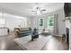 Sun-filled living room boasts hardwood floors, a cozy fireplace, and an open layout for entertaining at 389 Whetstone Dr, Angier, NC 27501