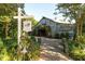 Charming barn with brick pathway, surrounded by lush landscaping and mature trees at 411 Brampton Close, Pittsboro, NC 27312