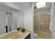 Bright bathroom featuring a tiled shower, marbled countertop, and modern fixtures at 411 Brampton Close, Pittsboro, NC 27312