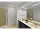 Bathroom featuring double sinks, framed mirrors, and a separate tiled shower at 411 Brampton Close, Pittsboro, NC 27312