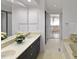 Hall bathroom featuring double sinks and a separate tub at 411 Brampton Close, Pittsboro, NC 27312