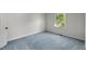 Bright bedroom featuring blue carpet, soft gray walls, and a standard window at 411 Brampton Close, Pittsboro, NC 27312