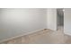 Simple bedroom with neutral carpet, soft gray walls, and a large doorway at 411 Brampton Close, Pittsboro, NC 27312