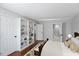 A bedroom featuring a built-in bookcase, warm lighting, and access to an en-suite bathroom at 411 Brampton Close, Pittsboro, NC 27312