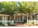 Inviting exterior with double doors, white picket fence, and professionally landscaped garden at 411 Brampton Close, Pittsboro, NC 27312
