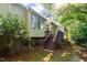 View of the home exterior, with steps leading to the deck and sunroom at 411 Brampton Close, Pittsboro, NC 27312