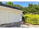 Attached garage with a white door on the exterior of the home at 411 Brampton Close, Pittsboro, NC 27312