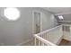 Second story hallway featuring neutral carpet, soft gray walls, and a decorative window at 411 Brampton Close, Pittsboro, NC 27312