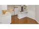 Kitchen featuring white cabinets, appliances, breakfast bar, and decorative wall shelving at 411 Brampton Close, Pittsboro, NC 27312