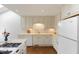 Well-lit kitchen featuring white cabinets, modern appliances, and a functional layout at 411 Brampton Close, Pittsboro, NC 27312
