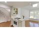 Bright kitchen features an island gas range cooktop, built-in shelving, and a sun-filled breakfast nook at 411 Brampton Close, Pittsboro, NC 27312