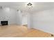 Open living room with hardwood floors and a view of the fireplace at 411 Brampton Close, Pittsboro, NC 27312