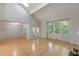 Spacious living room featuring hardwood floors, vaulted ceilings, and a flood of natural light at 411 Brampton Close, Pittsboro, NC 27312