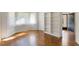 Bright living room featuring parquet floors, bay window, and a built-in bookcase near front entry at 411 Brampton Close, Pittsboro, NC 27312
