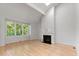 Bright living room with hardwood floors, fireplace, and large windows offering natural light at 411 Brampton Close, Pittsboro, NC 27312