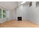 Inviting living room with hardwood floors, a cozy fireplace, and ample natural light from large windows at 411 Brampton Close, Pittsboro, NC 27312