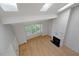 Open floor plan living room features skylights, hardwood floors, and a fireplace at 411 Brampton Close, Pittsboro, NC 27312