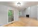 Bright living room with hardwood floors, fireplace, and a view of the screened porch at 411 Brampton Close, Pittsboro, NC 27312
