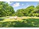 Scenic pasture with grazing sheep under a sunny sky surrounded by lush trees at 411 Brampton Close, Pittsboro, NC 27312