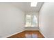 Bright room with natural light from a window, featuring hardwood floors and neutral walls at 411 Brampton Close, Pittsboro, NC 27312