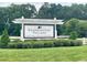 Fearrington Village community sign with trees and landscaping in the background at 411 Brampton Close, Pittsboro, NC 27312
