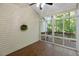 Sunroom featuring brick flooring, ceiling fan, and views of the natural green backyard at 411 Brampton Close, Pittsboro, NC 27312