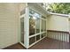 Exterior view of a sunroom featuring many windows and access to the deck at 411 Brampton Close, Pittsboro, NC 27312