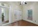 Sunroom features brick flooring, ceiling fan, white framed windows, and access to the backyard at 411 Brampton Close, Pittsboro, NC 27312