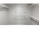 Walk-in closet featuring white metal and laminated wood shelving at 411 Brampton Close, Pittsboro, NC 27312